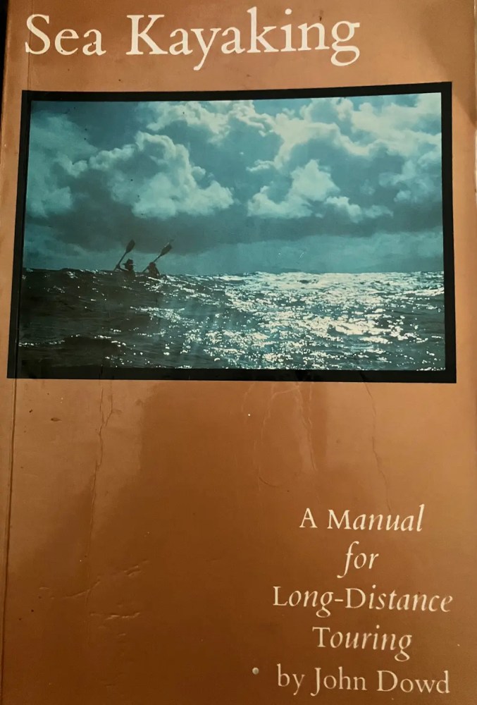 Book cover: 'Sea Kayaking' with kayaker photo on ocean.